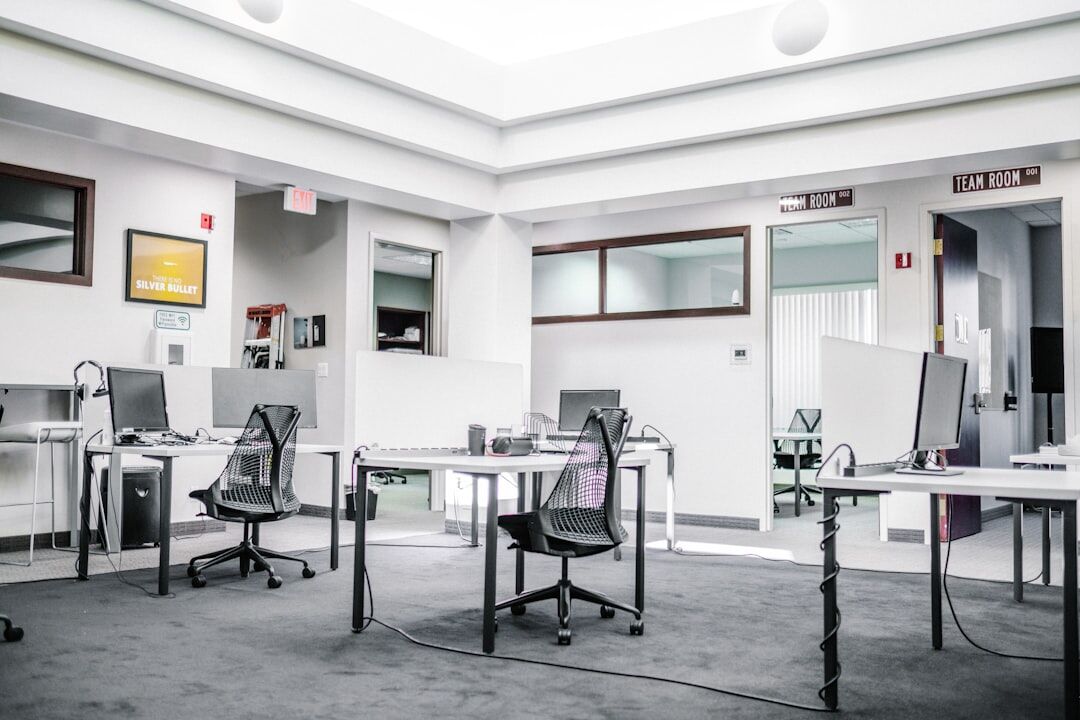 Modern newsroom office with computers and screens
