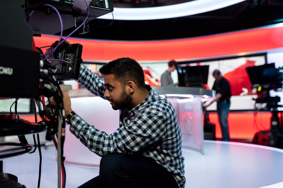 TV news studio with presenter at anchor desk
